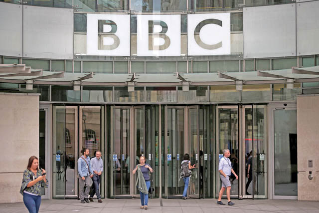 Staff and visitors walk outside the headquarters of the British Broadcasting Corporation (BBC) in central London on Wednesday (AFP photo)